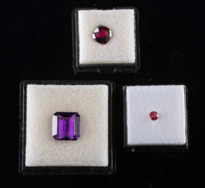 Lot 328, Auction 3/19/2026: Three Faceted Gemstones: Garnet, Ruby & Amethyst