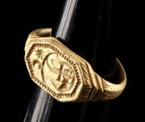 Lot 148a, Auction 4/3/2026: 15th C. English Medieval Gold Ring - Arm & Sword Crest